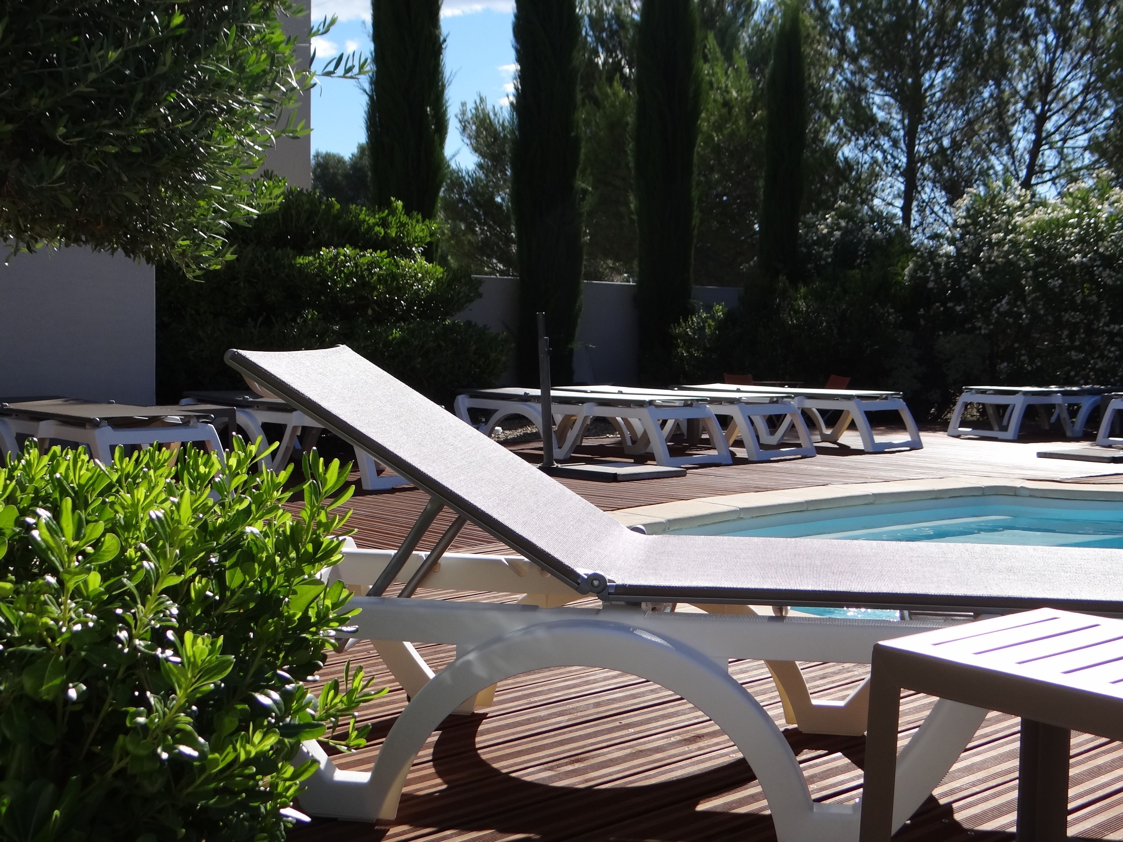 outdoor pool, open 9:00 am to 8:00 pm, pool umbrellas, pool loungers
