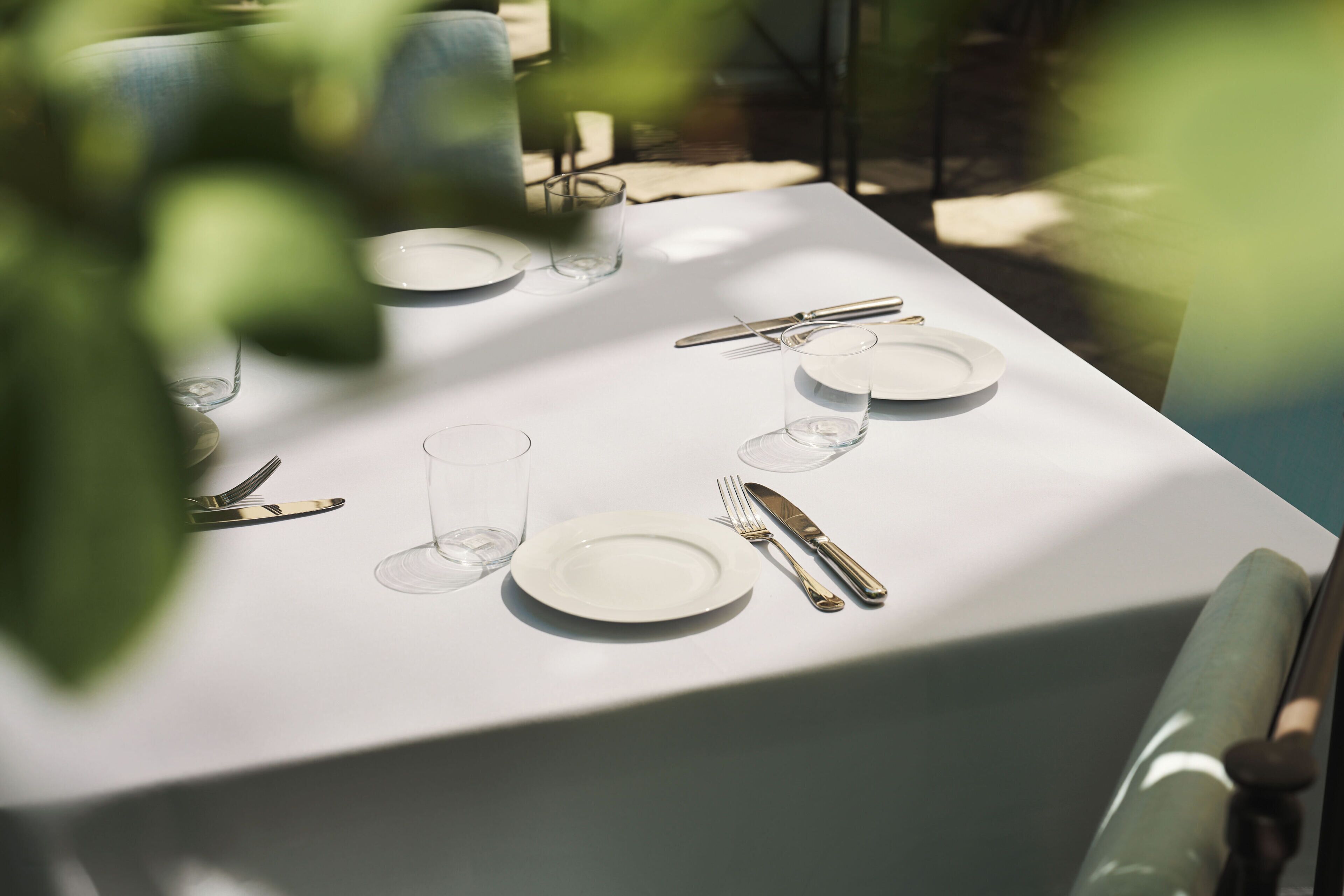 A table set for a meal with plates, glasses, and cutlery.