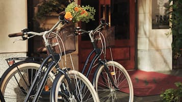Two bicycles parked outside a building with a number '788' visible on the wall.