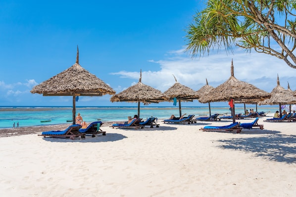 On the beach, sun-loungers, beach umbrellas, beach towels