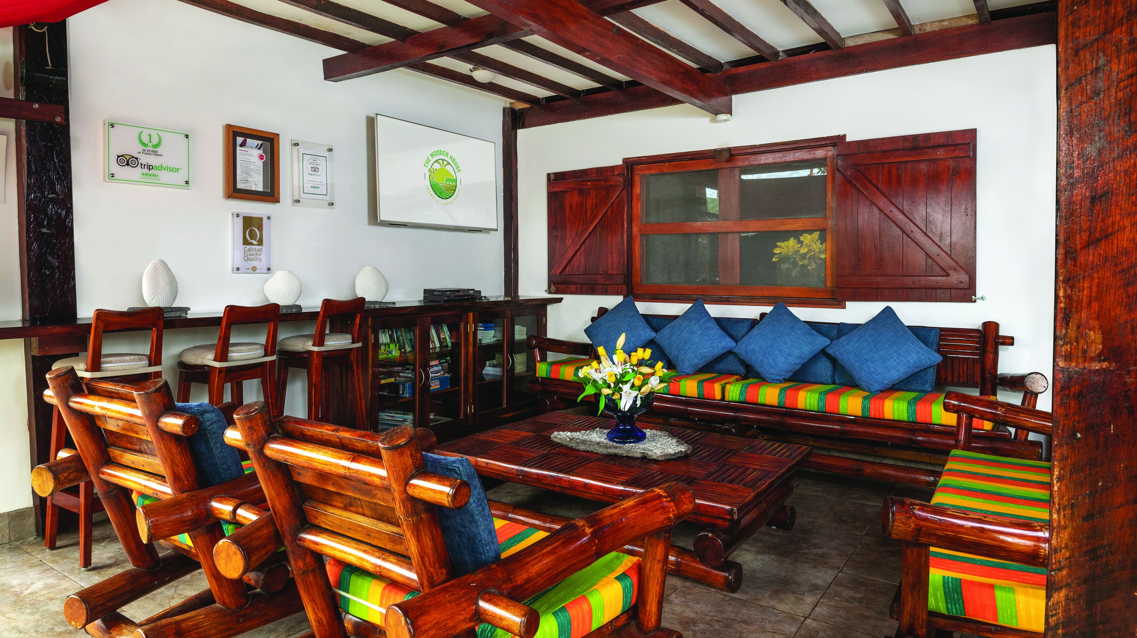A traditional wooden interior with a sofa set, chairs, and a coffee table.
