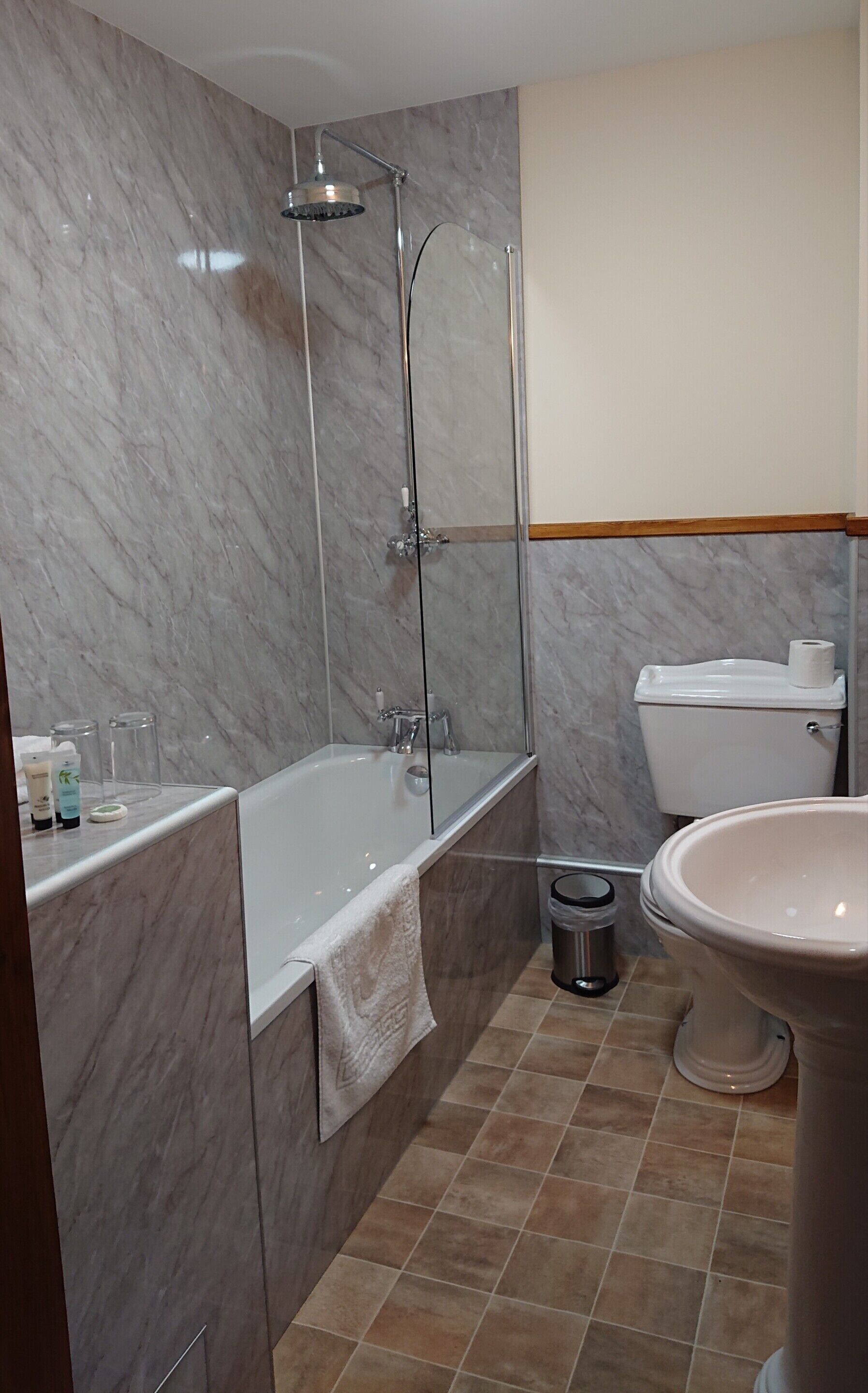 A bathroom with a bathtub, toilet, and shower.