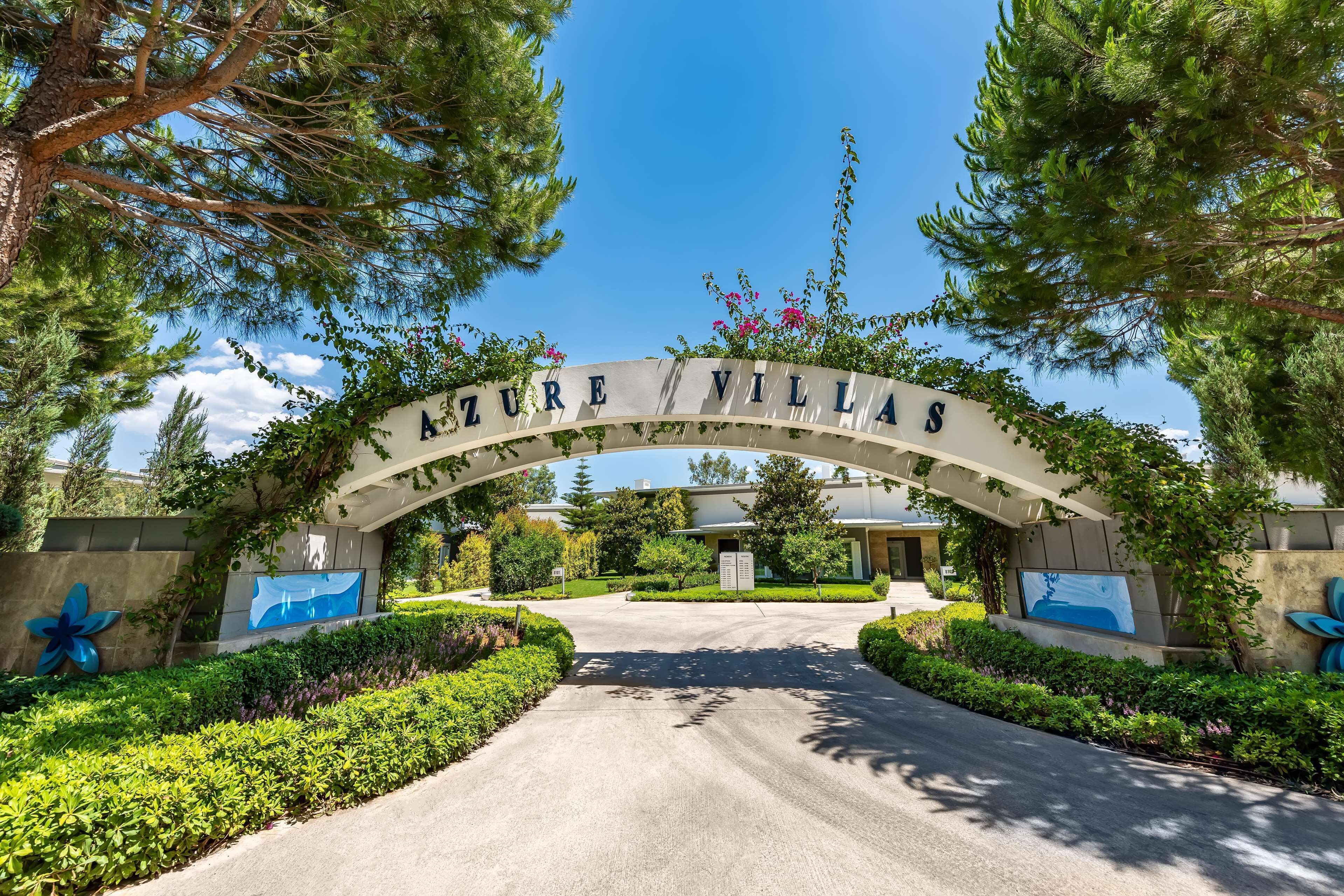 A sign reading "AZURE VILLAS" with a clear pathway leading to the entrance.