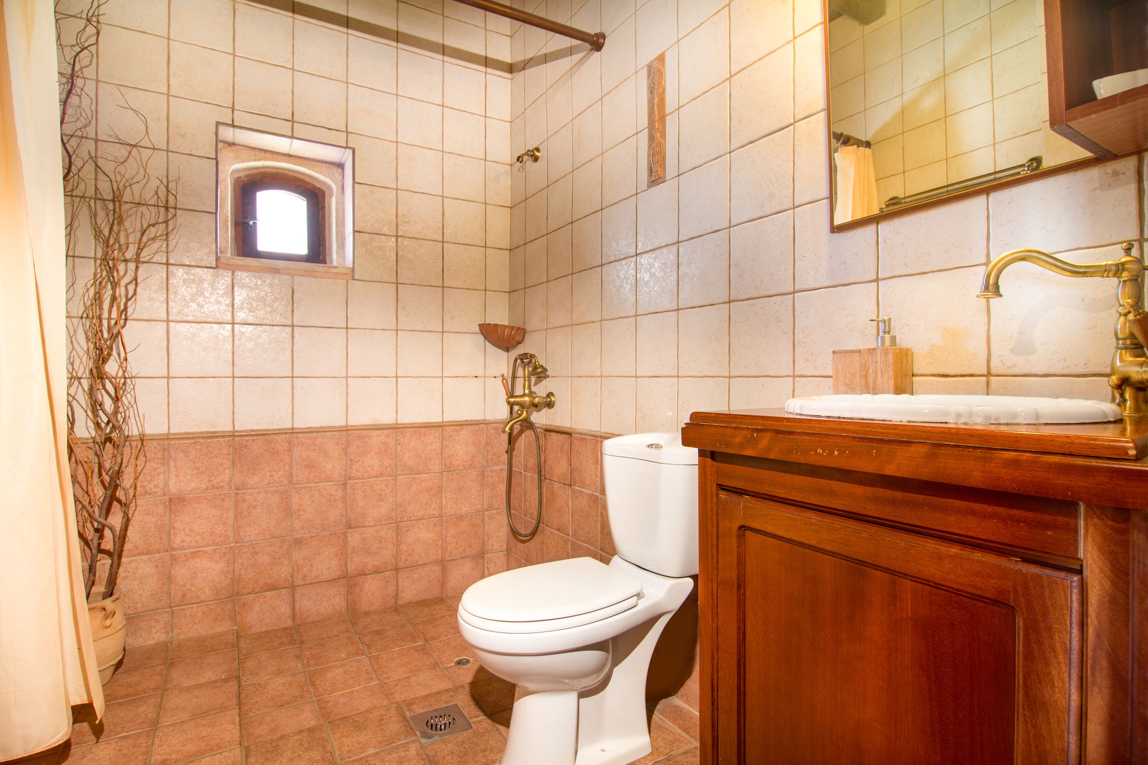 A bathroom with a toilet, a sink, and a shower.