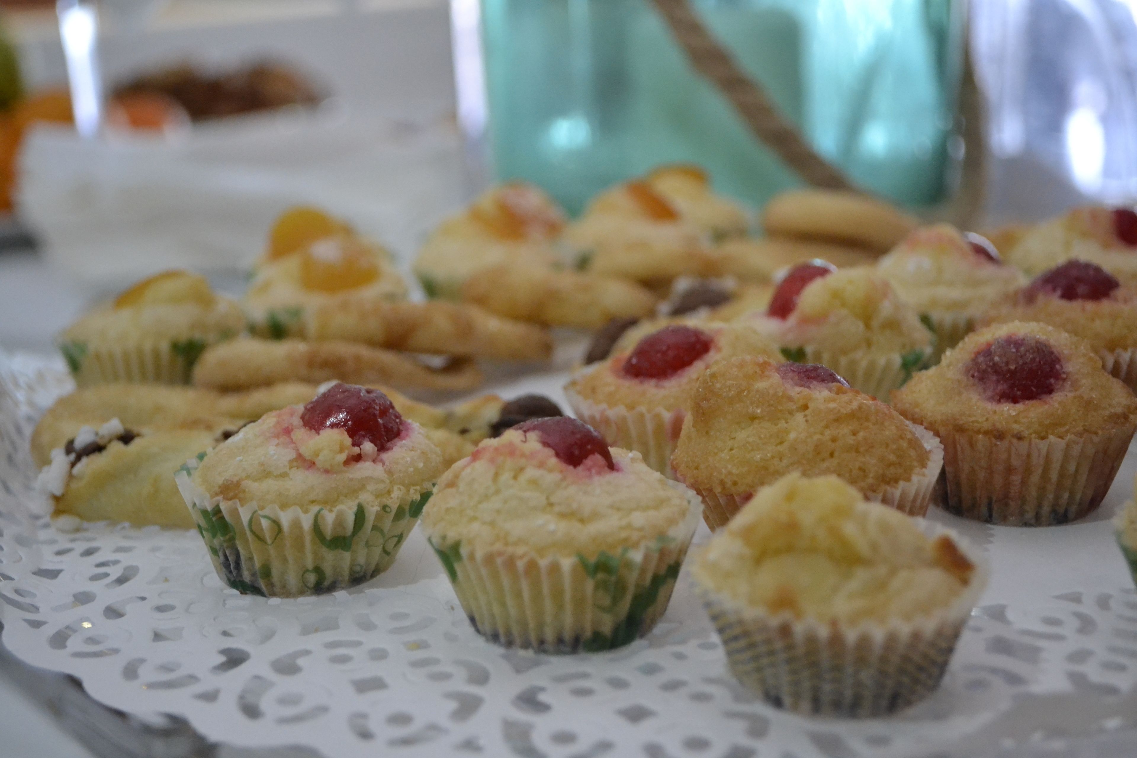 A tray of assorted muffins on a lace doily.