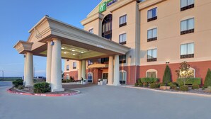 A Holiday Inn Express building with a covered entrance, multiple windows, and a clear sky. - Holiday Inn Express & Suites Altus by IHG (Altus)