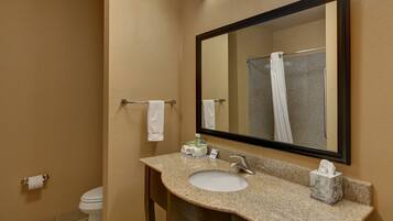 A bathroom with a sink, mirror, towel rack, and toilet.