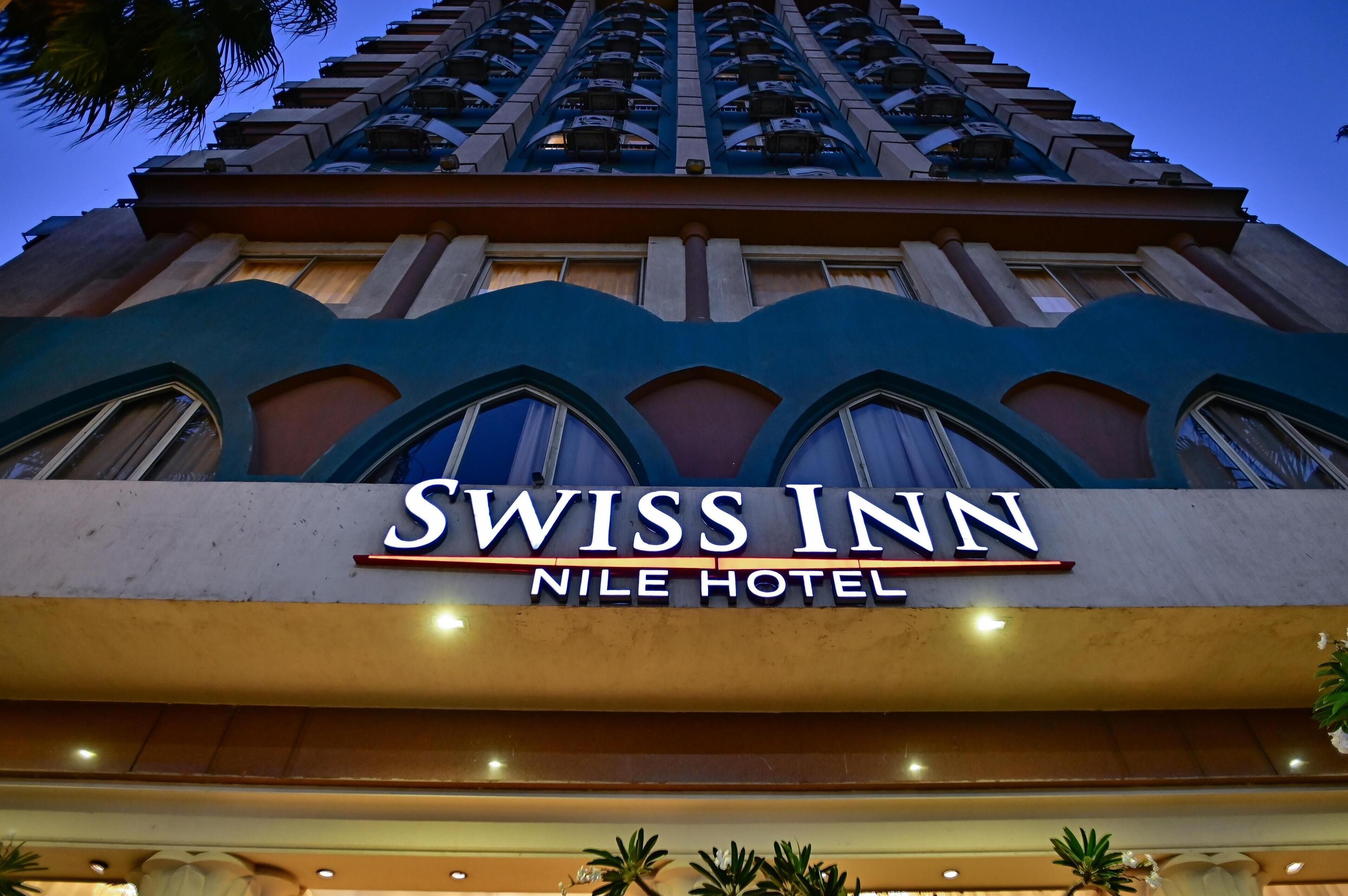 The exterior of the Swiss Inn Nile Hotel with a prominent sign.