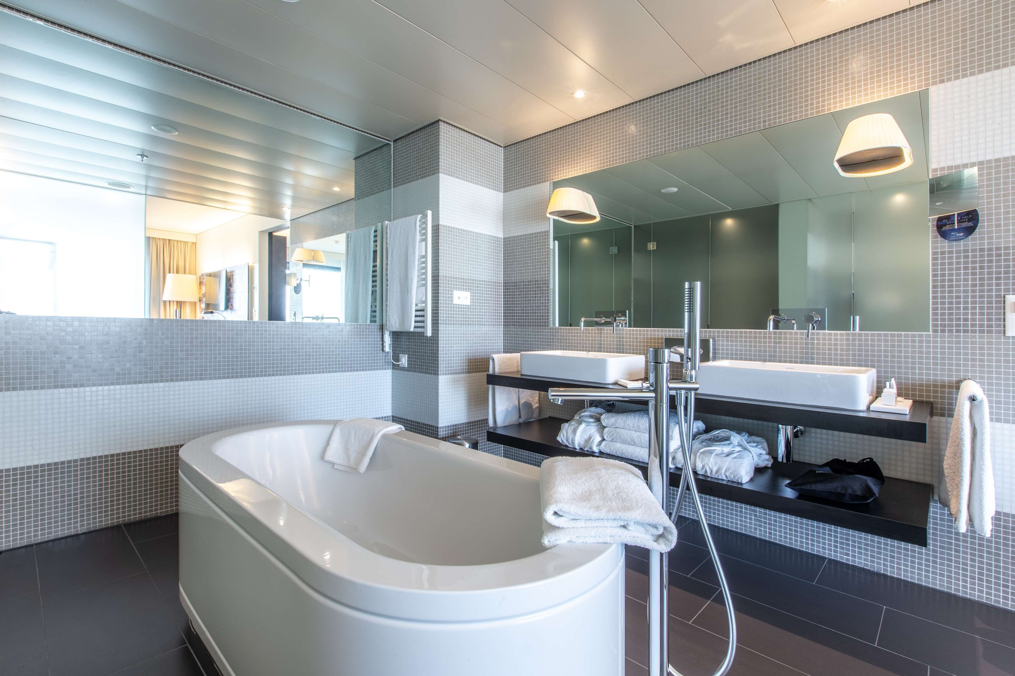 design suite (airfield view) | bathroom | combined shower/bathtub, eco-friendly toiletries, hair dryer, towels