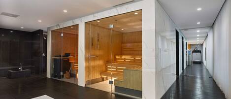 A modern hotel lobby with a marble reception desk, wooden interior, and a long corridor leading to elevators.