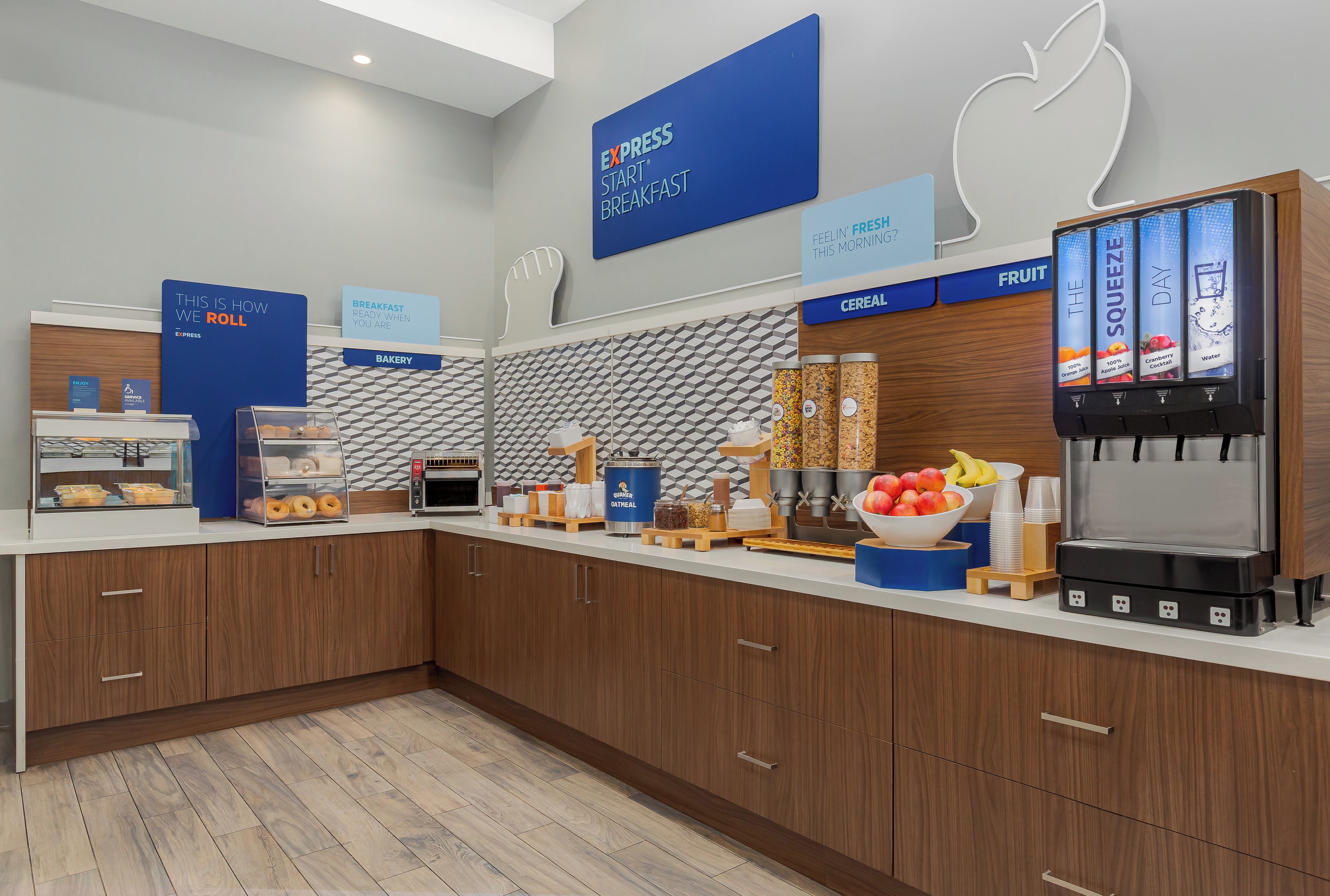A breakfast area with a self-serve station, bakery section, and cereal display.