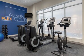 A gym with cardio equipment, a wall with motivational text, and a large window. - Holiday Inn Express Hotel & Suites Toronto - Markham by IHG (Richmond Hill)
