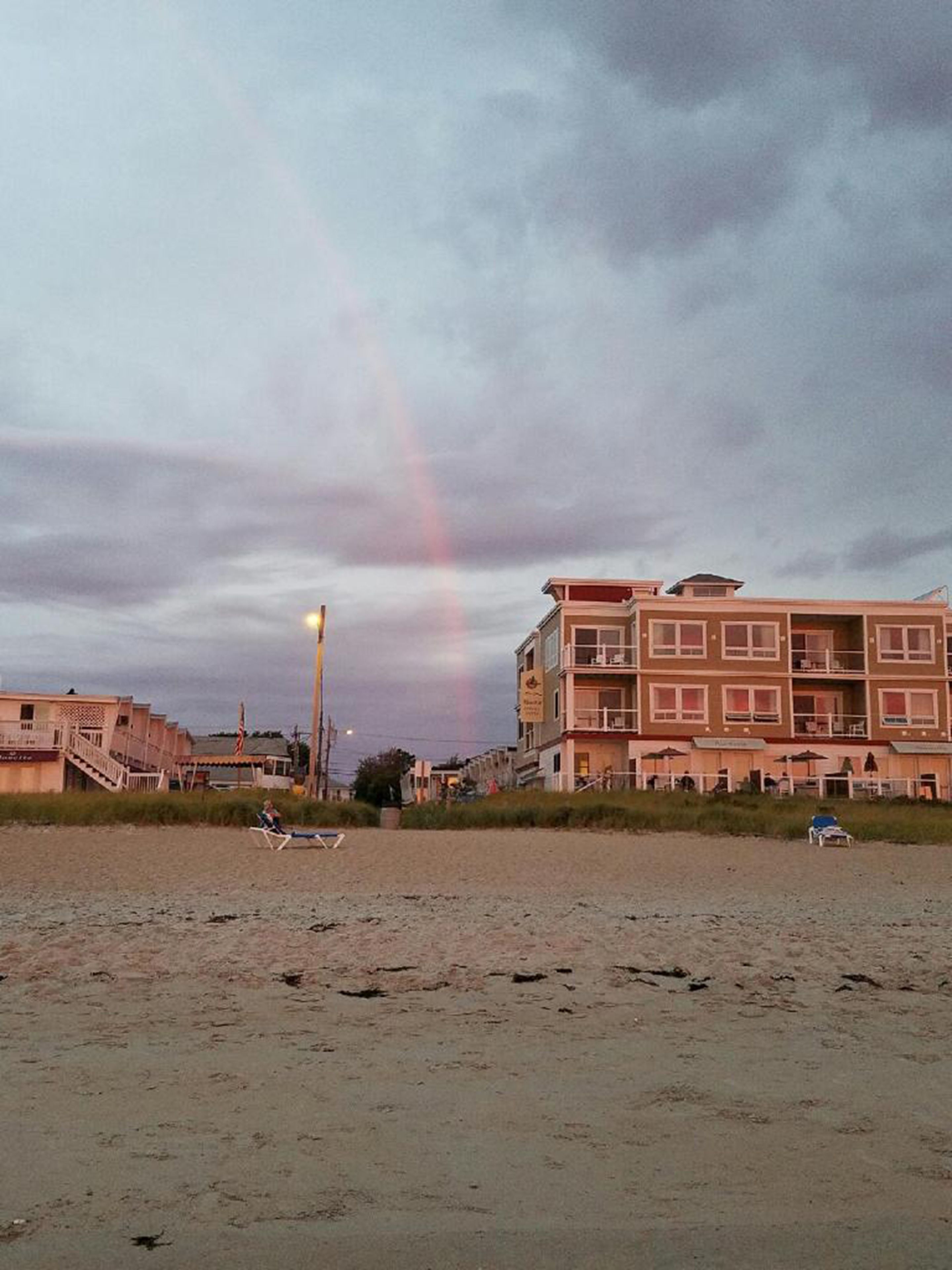 A beach with a building in the background.