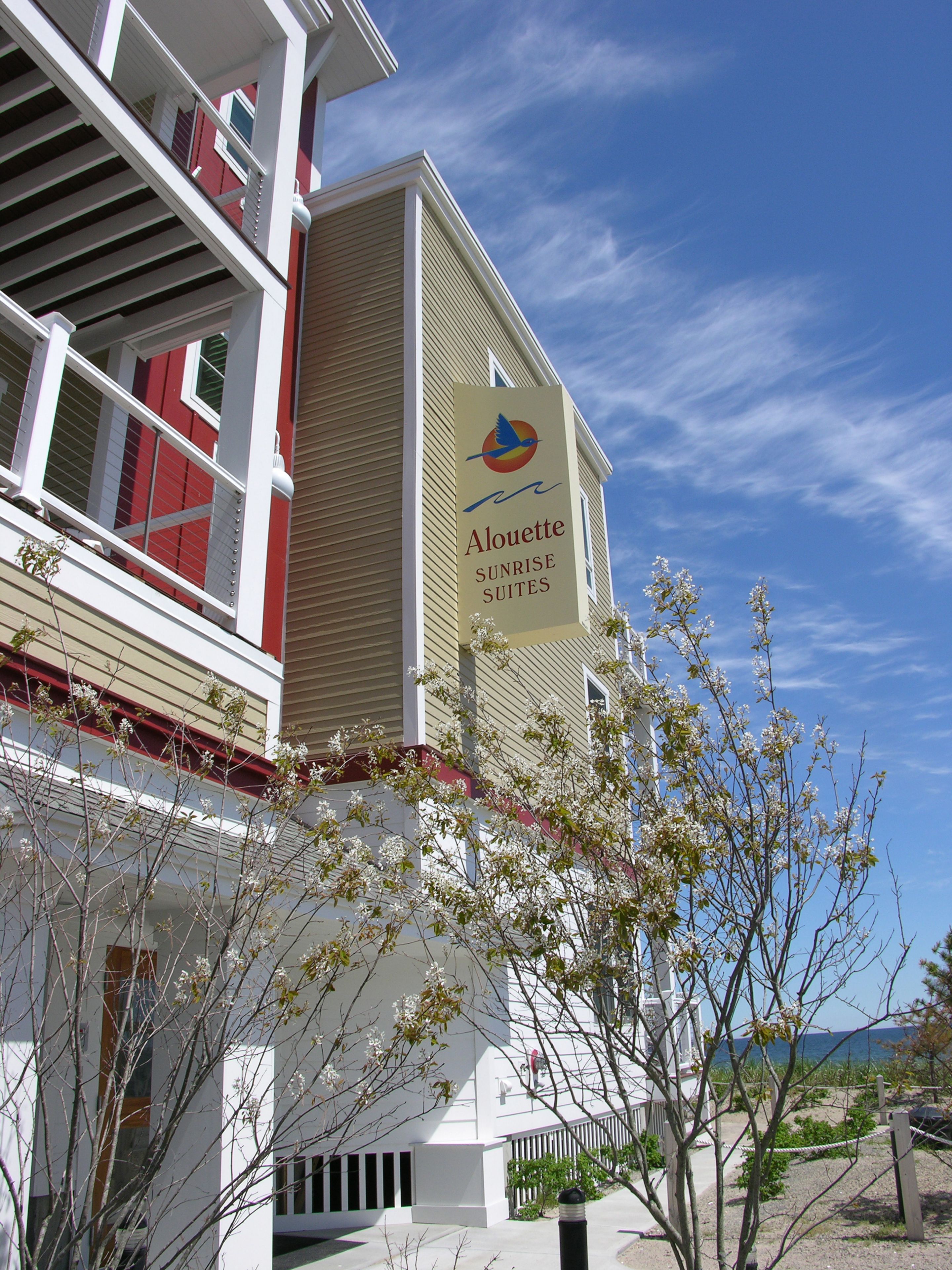 A building with a sign for 'Aloette Sunrise Suites'.