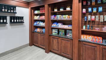 A well-organized pantry with shelves stocked with various food items and beverages.