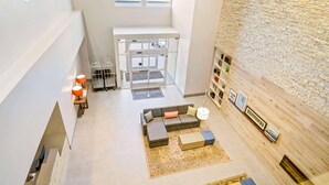 A spacious lobby with a modern sofa, a coffee table, a rug, and a wall with framed pictures.