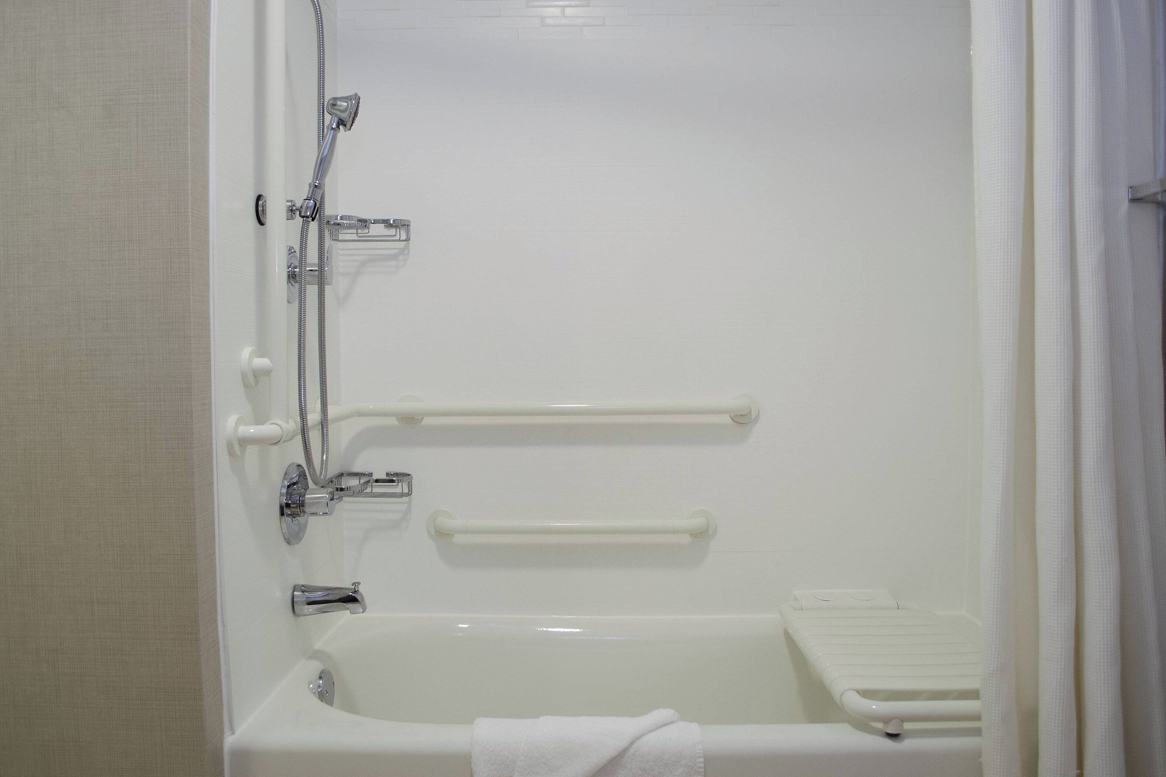 A bathroom with a bathtub, a shower, and a toilet.