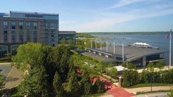 A modern building with a parking lot and a waterfront view.
