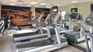 A gym with multiple treadmills, stationary bikes, and weight machines. - Springhill Suites by Marriott Oklahoma City Airport (Oklahoma City)