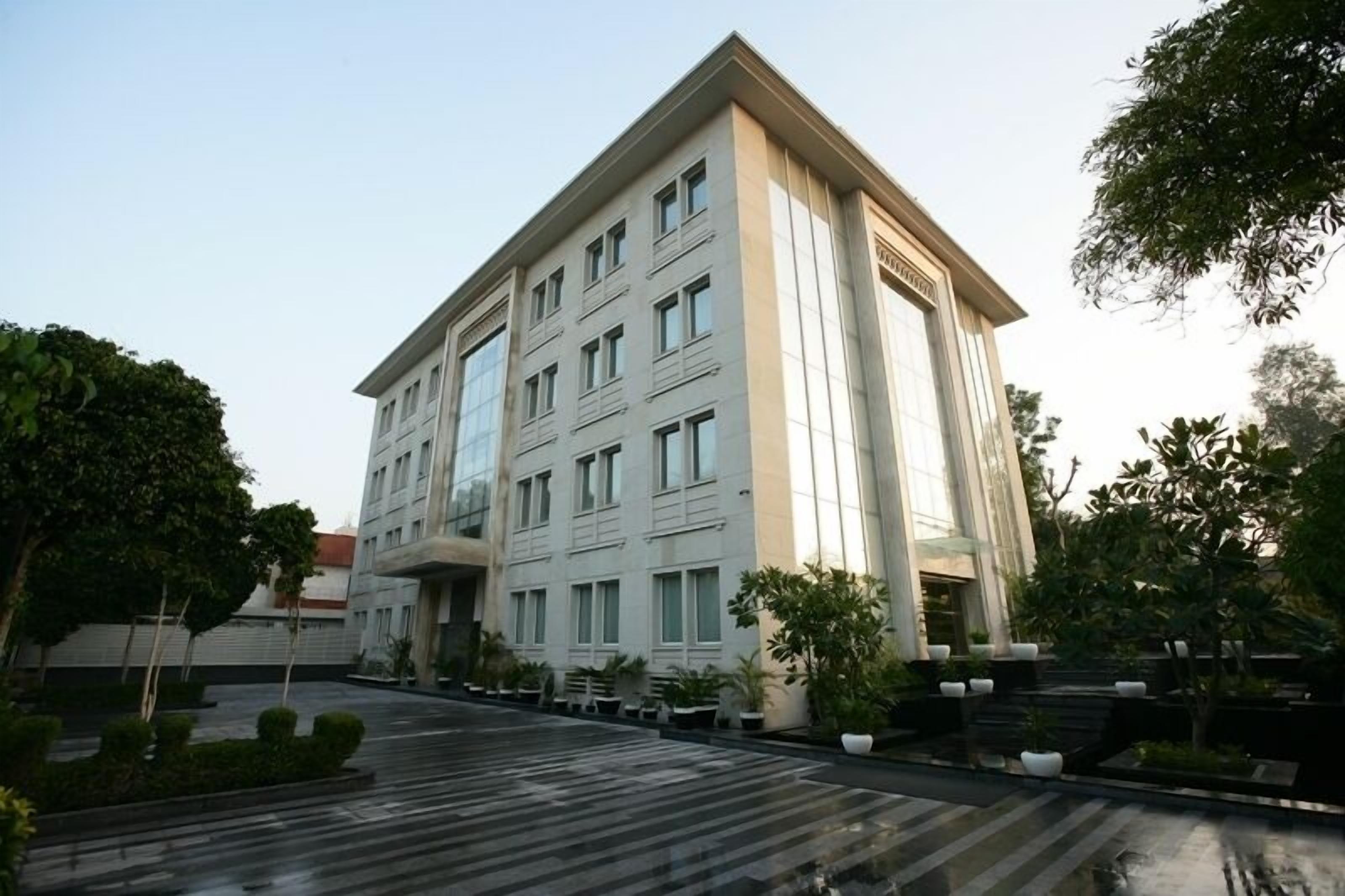 A modern multi-story hotel with a symmetrical facade, large windows, and a central entrance.