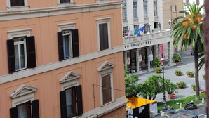 A multi-story building with a balcony and a sign that reads "RO DELL'OPERA". - My Monti Place (Rome)