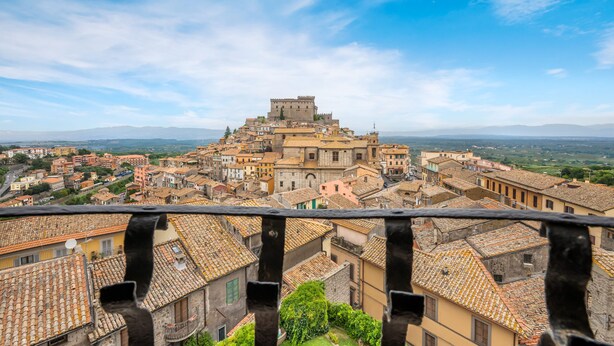 A historic town with a prominent castle-like structure on a hill, surrounded by traditional buildings with terracotta roofs. - Hilton Vacation Club Palazzo Catalani & Soriano (Soriano nel Cimino)