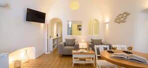 Junior Suite with hot tub & caldera view | Living area | 32-inch Smart TV with satellite channels