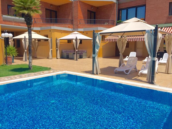Seasonal outdoor pool, pool umbrellas, pool loungers