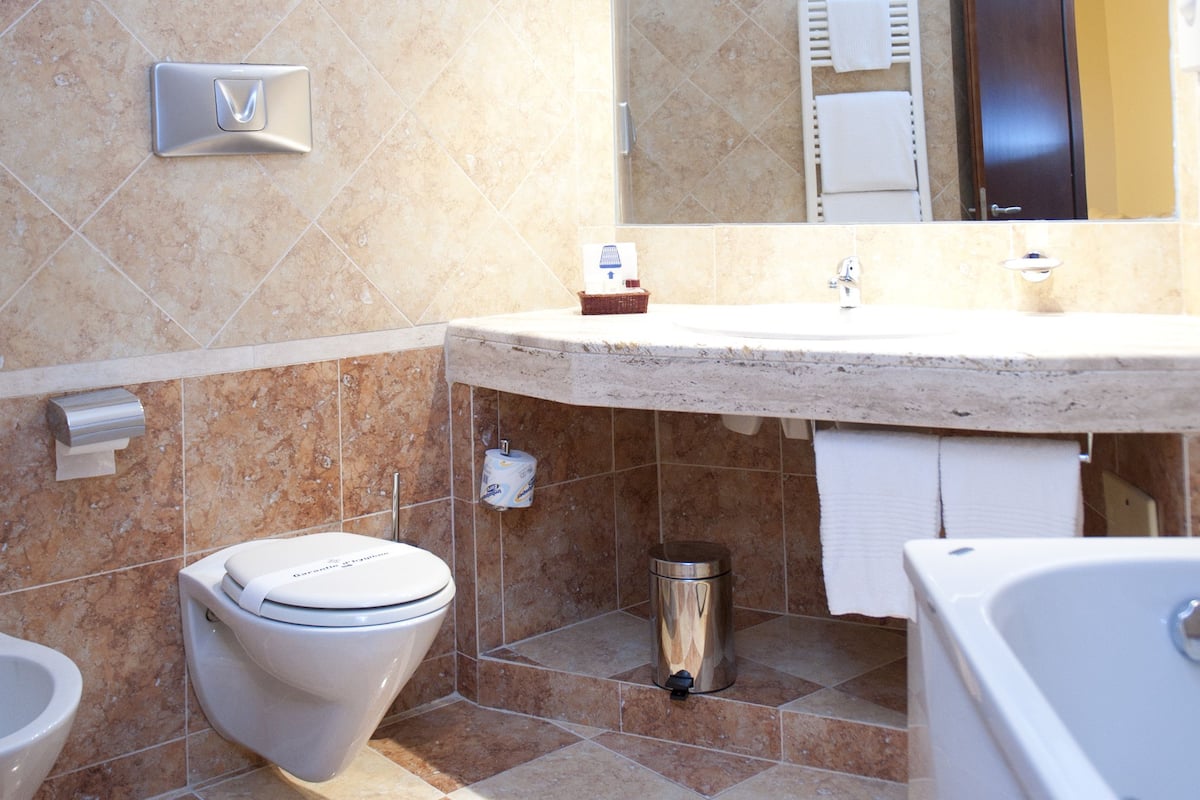junior suite, balcony | bathroom | combined shower/bathtub, deep-soaking bathtub, rainfall showerhead