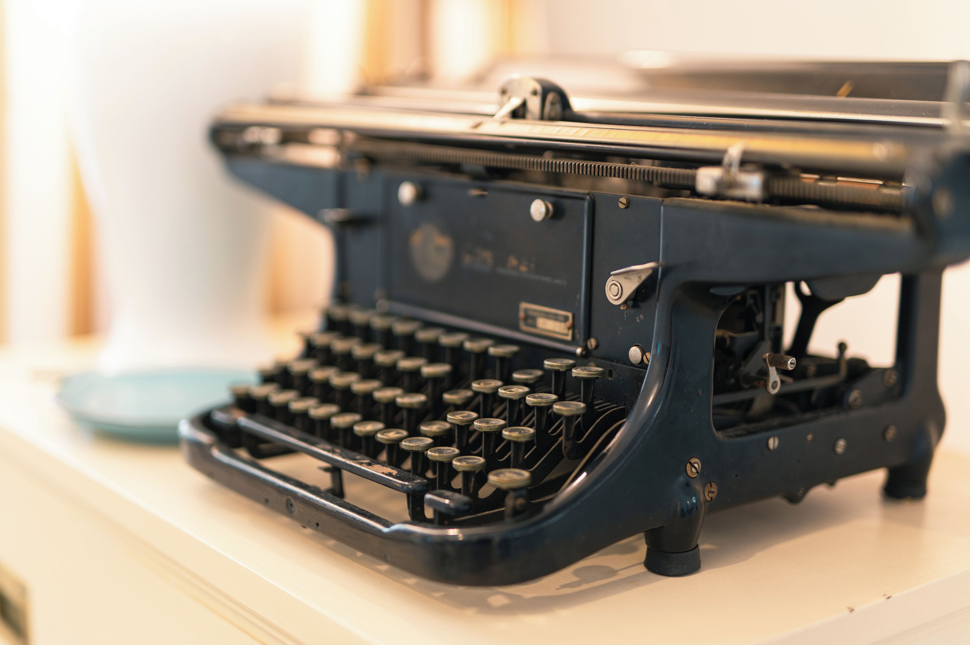 A vintage typewriter with a metal body and black keys.
