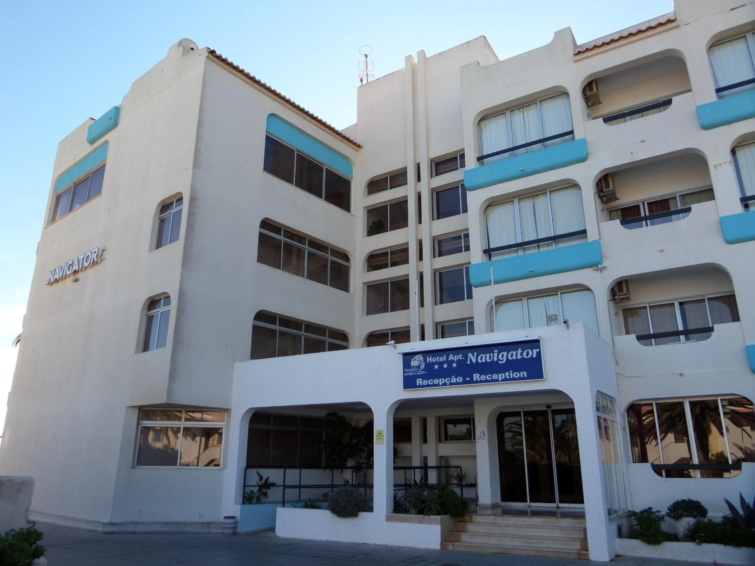 A hotel named Navigator with a reception area and multiple balconies.