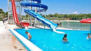 A water park with multiple slides and a pool area.