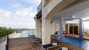 A poolside area with lounge chairs, a pool, and a view of the landscape. - Recó de Randa (Algaida)