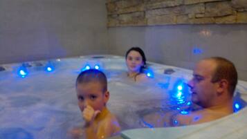 Relax in the hot tub surrounded by soothing ambiance.