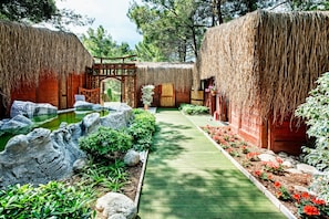 Stroll through the serene garden, surrounded by lush greenery and a tranquil pond.