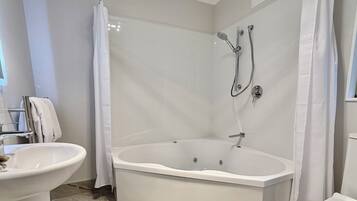 A modern bathroom with a freestanding bathtub, a separate shower area, and a vanity with a sink.