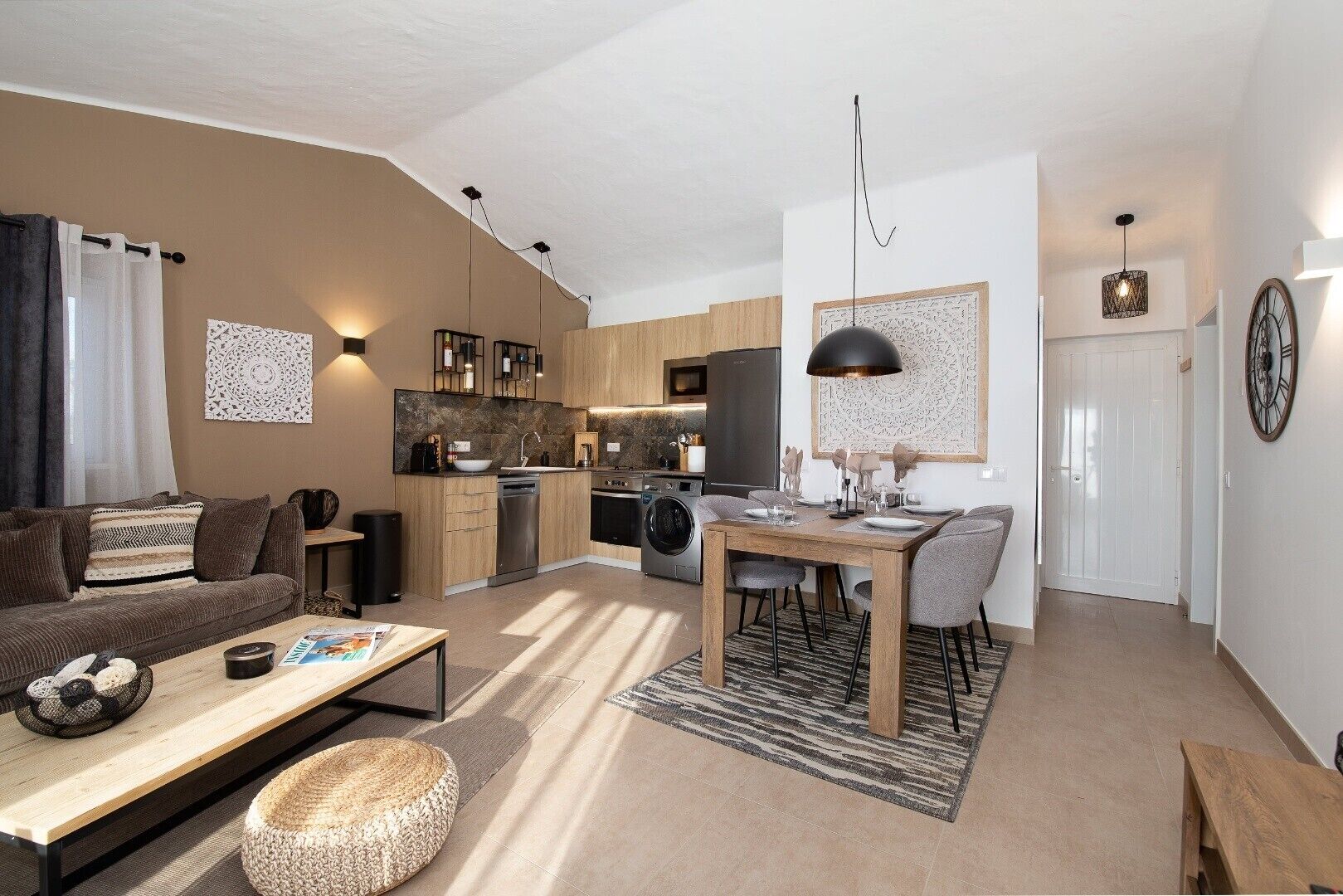 A modern apartment with a living room, dining area, and kitchen.