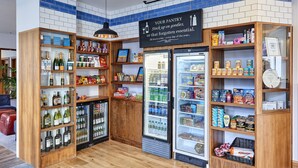 A well-stocked pantry with shelves of snacks, beverages, and condiments.