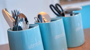 Three blue containers with utensils inside, labeled 'utensils.'