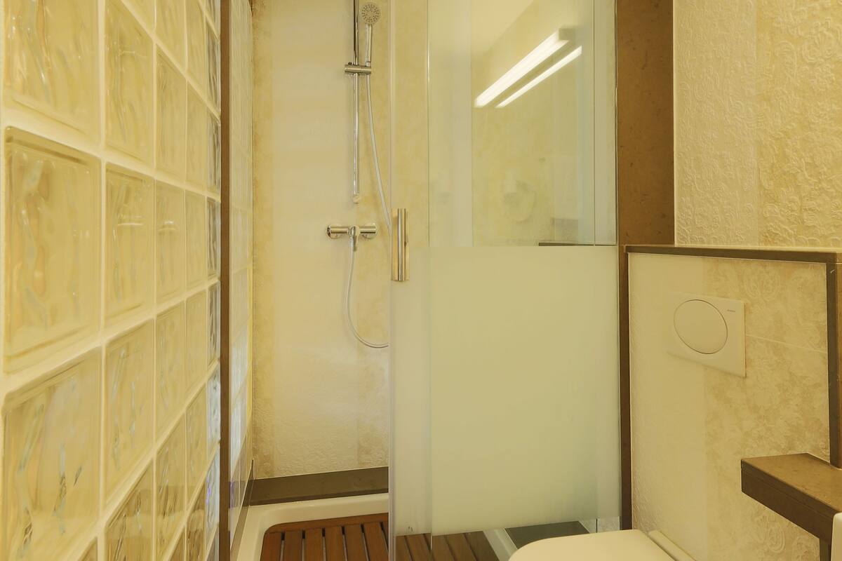double room | bathroom | shower, rainfall showerhead, hair dryer, slippers