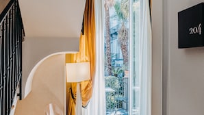 A modern hotel entrance with a clear glass door, a staircase, and a number sign '204'. - Costantinopoli 104 (Naples)