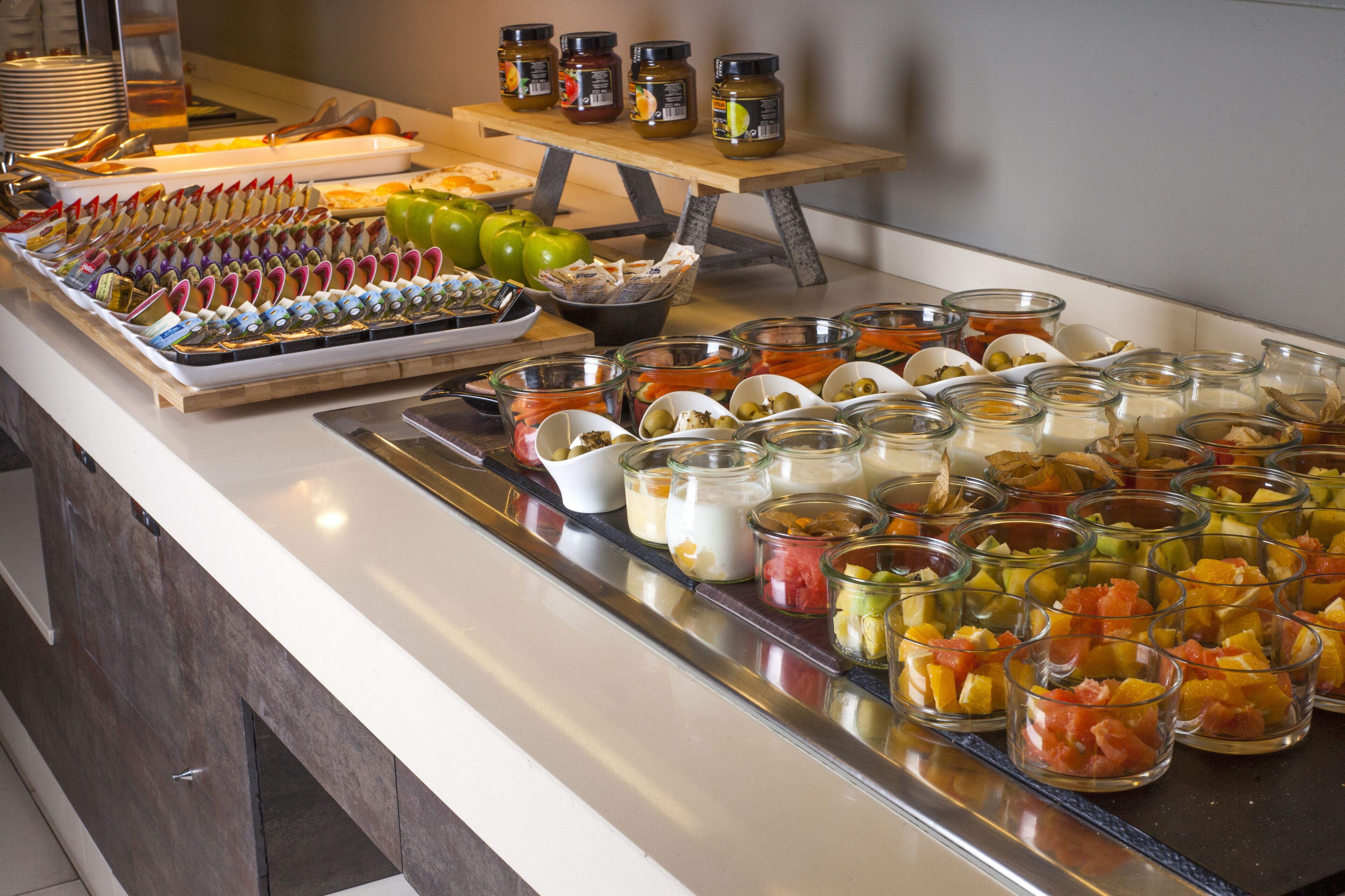 A buffet with various food items and condiments.