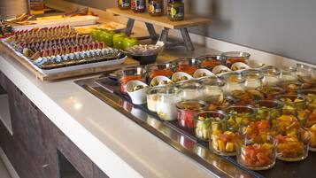 A buffet with various food items and condiments.