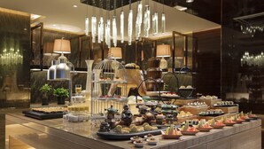 A buffet setup with various food items and decorative elements. - Hilton Xiamen (Xiamen)