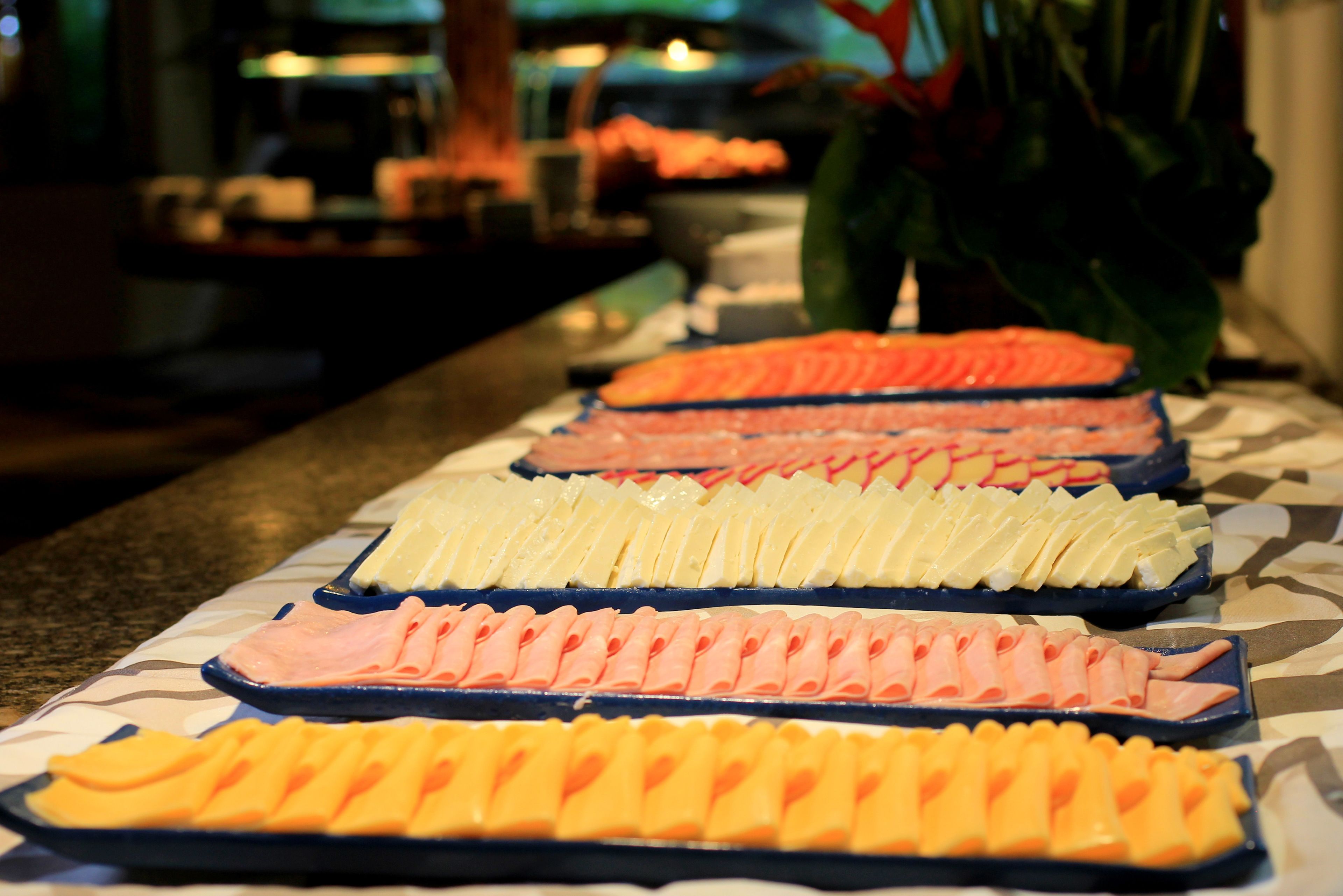 A buffet with various food items arranged in trays.