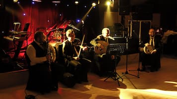 A band performing on a stage with musical instruments and a keyboard.
