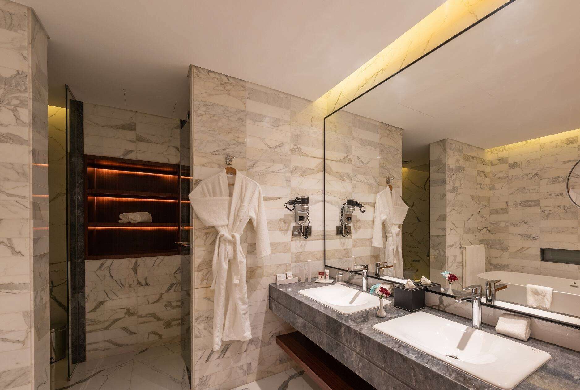 junior suite, 1 king bed, non smoking | bathroom | deep-soaking bathtub, hair dryer, bathrobes, slippers