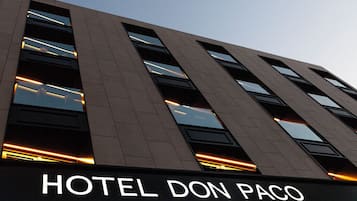 A modern building with the sign "HOTEL DON PACO" indicating a hotel establishment.