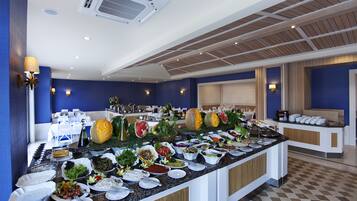 A buffet with various food items and a check-in counter.