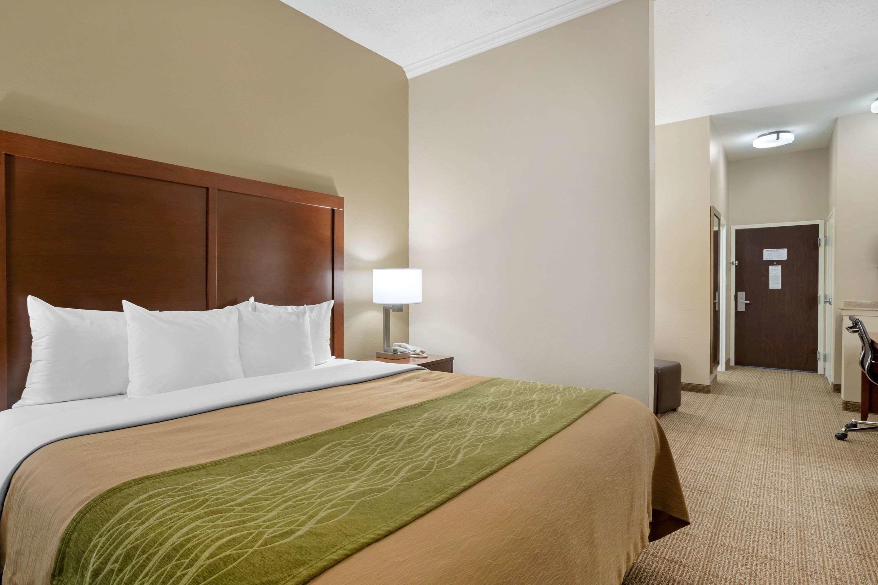 Premium bedding, desk, laptop workspace, blackout drapes